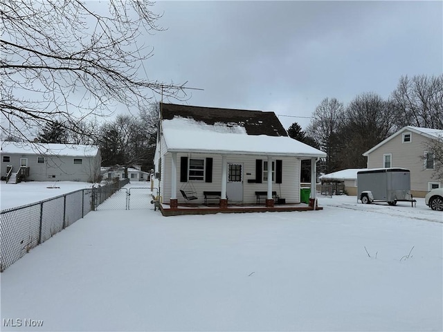 bungalow-style house featuring covered porch and fence