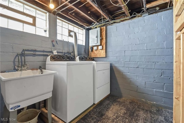 laundry area featuring laundry area, washing machine and dryer, and electric panel