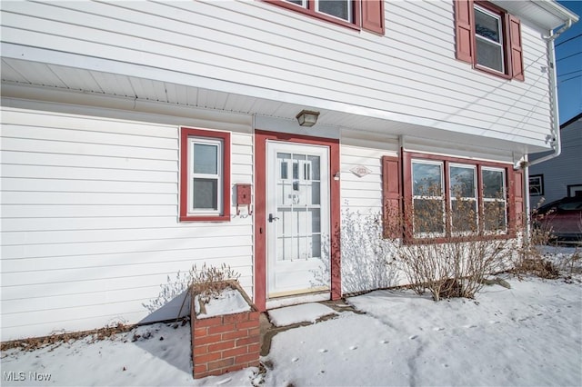 view of snow covered property entrance