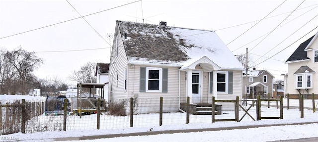 view of front of property with a shingled roof and fence