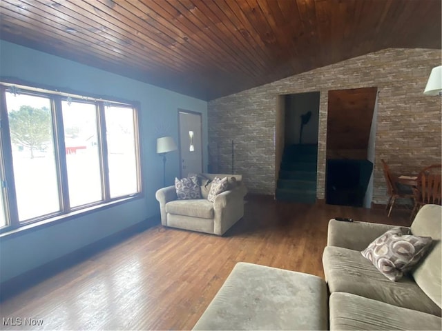 living area with vaulted ceiling, wood ceiling, and wood finished floors