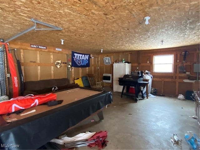 recreation room with concrete flooring and a garage