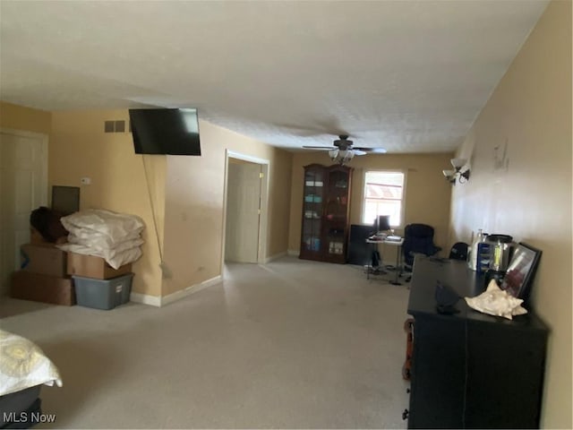 interior space featuring visible vents, baseboards, and a ceiling fan