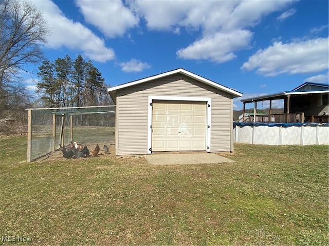 detached garage featuring a covered pool