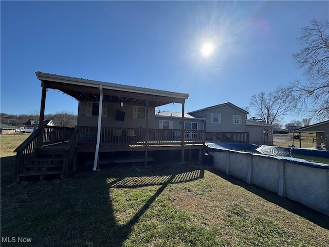 view of yard with a wooden deck and a covered pool