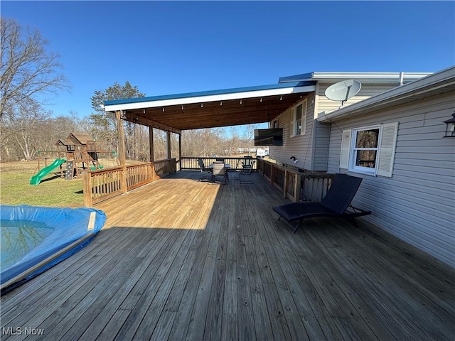 wooden deck featuring a playground