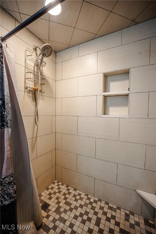 bathroom with tiled shower