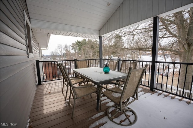 snow covered deck featuring outdoor dining area