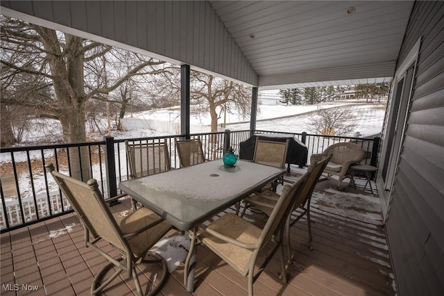 snow covered deck featuring outdoor dining area