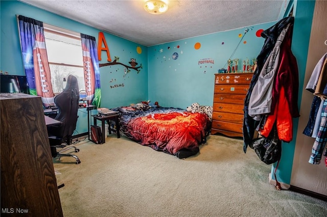 bedroom featuring carpet and a textured ceiling