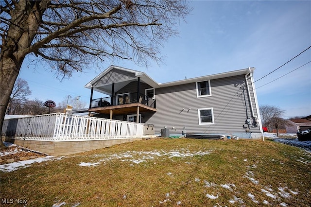 back of property featuring a yard and a balcony