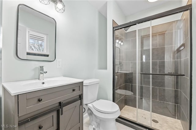 full bath with toilet, a shower stall, and vanity