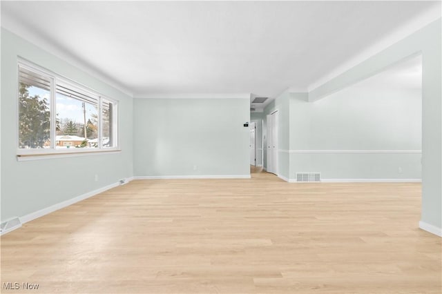 interior space featuring visible vents, light wood-style flooring, and baseboards