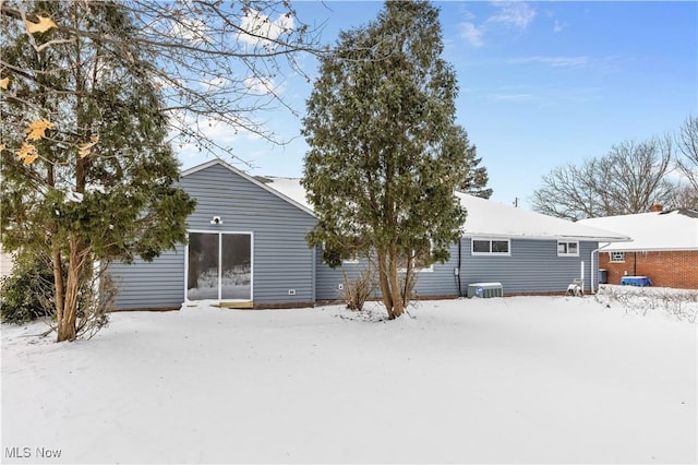 snow covered house with central AC