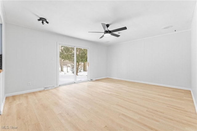 unfurnished room featuring baseboards, light wood-style flooring, visible vents, and a ceiling fan