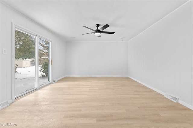 unfurnished room featuring ceiling fan, light wood finished floors, visible vents, and baseboards