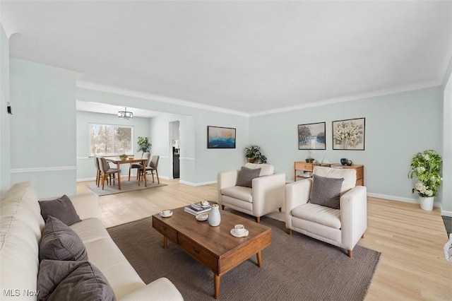 living room featuring light wood-style flooring and baseboards