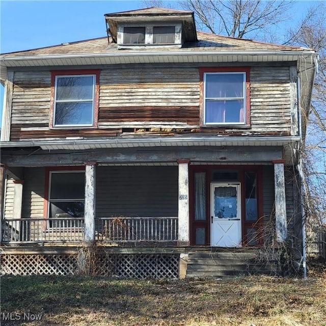 american foursquare style home with covered porch