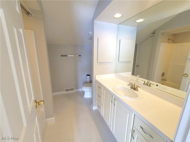 bathroom with bathtub / shower combination, toilet, visible vents, vanity, and baseboards