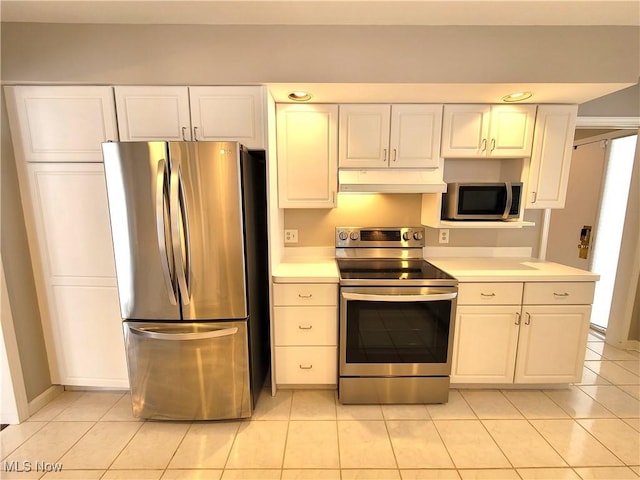 kitchen with under cabinet range hood, white cabinetry, appliances with stainless steel finishes, and light countertops