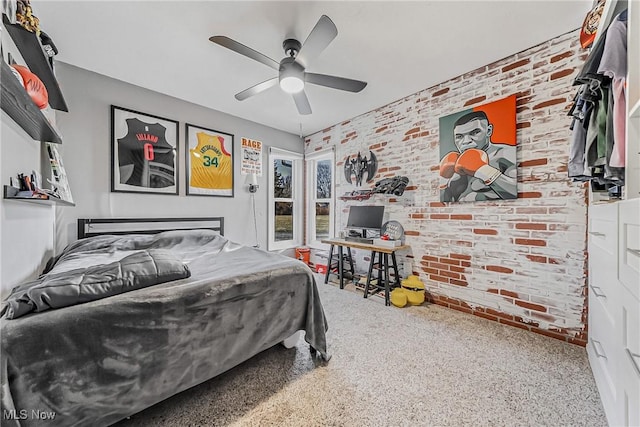 bedroom featuring carpet, ceiling fan, and brick wall