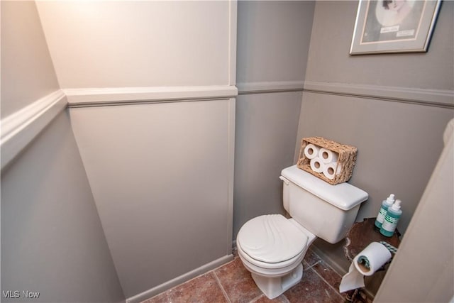 half bath featuring toilet and tile patterned floors