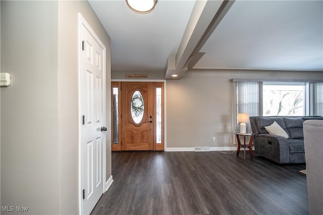 foyer entrance featuring dark wood-type flooring, visible vents, and a healthy amount of sunlight