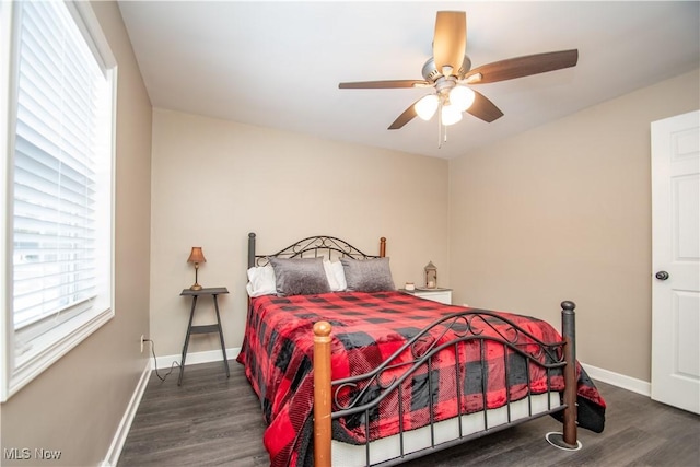 bedroom with dark wood finished floors, baseboards, and ceiling fan