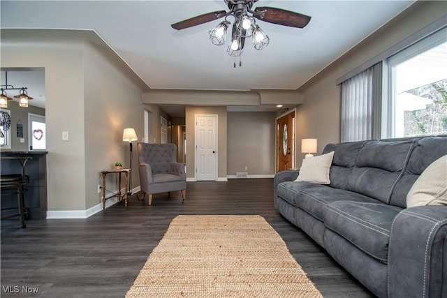 living room with a ceiling fan, dark wood finished floors, visible vents, and baseboards