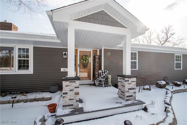 view of snow covered property entrance