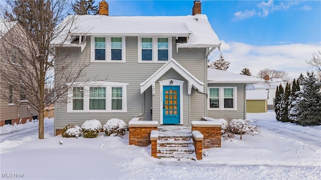 view of front of house featuring a chimney