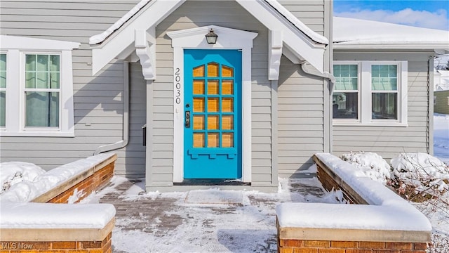 view of snow covered property entrance