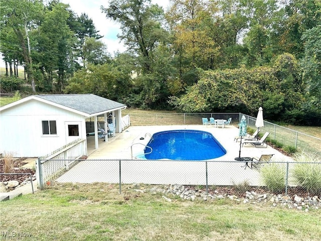 view of pool featuring a fenced in pool, a patio area, a fenced backyard, and a lawn