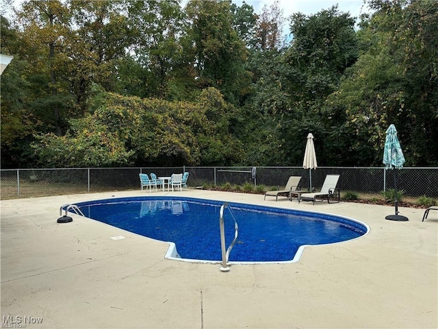 view of pool with a patio area, fence, and a fenced in pool