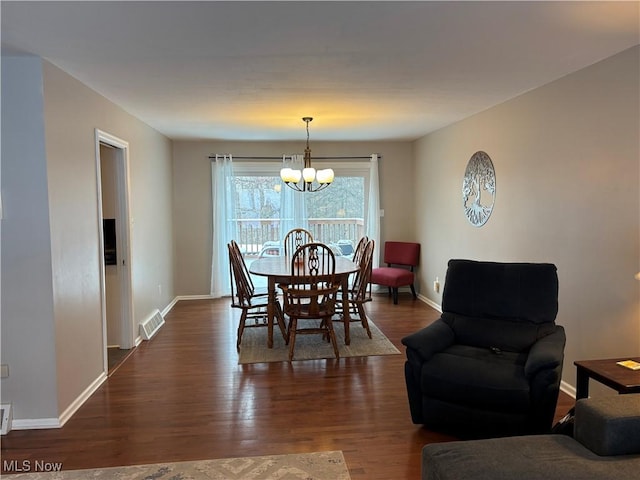 dining room with dark wood-style floors, visible vents, baseboards, and an inviting chandelier