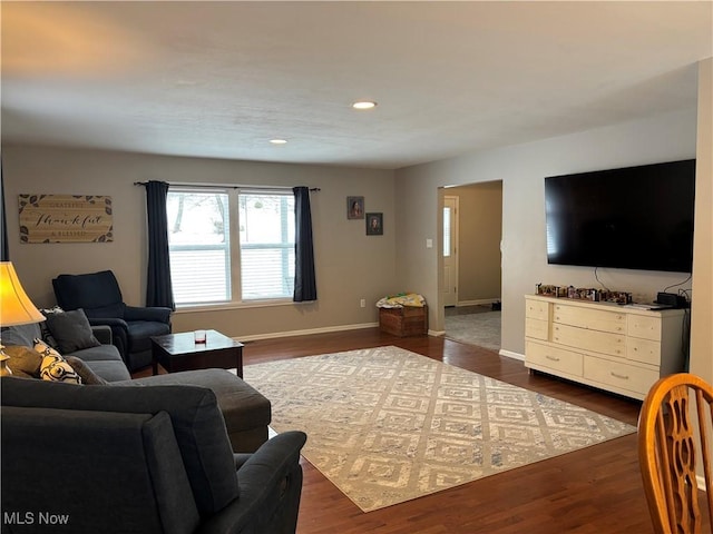 living area featuring baseboards, dark wood-style flooring, and recessed lighting