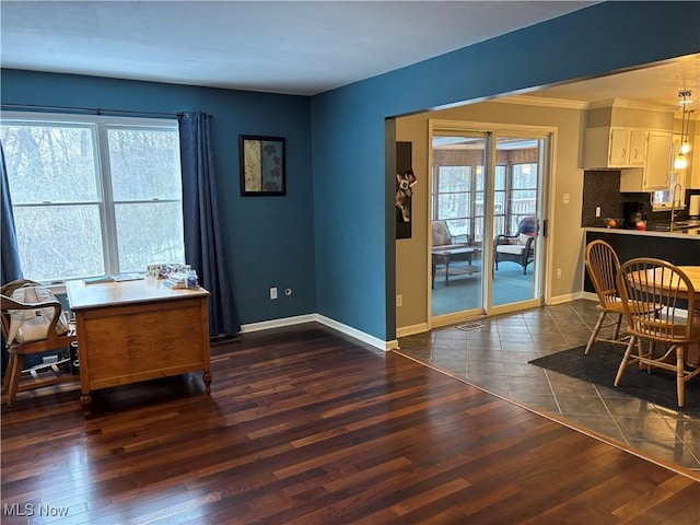 home office featuring dark wood-type flooring, visible vents, and baseboards