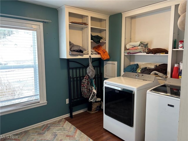 clothes washing area with washer and dryer, laundry area, baseboards, and dark wood-style flooring