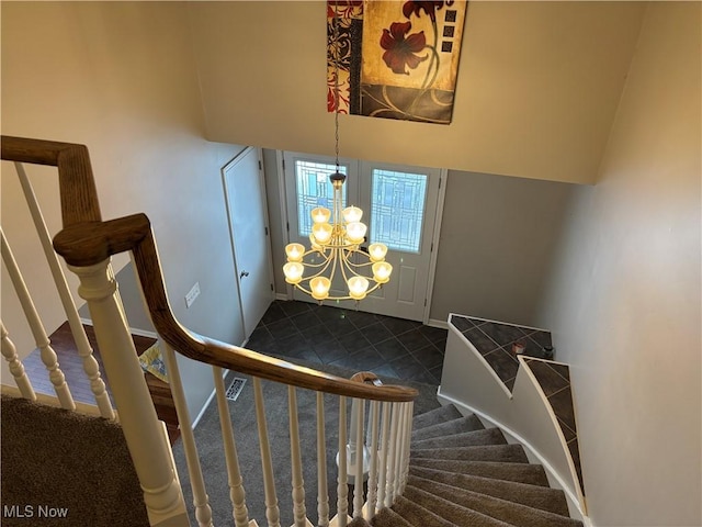 stairs with an inviting chandelier