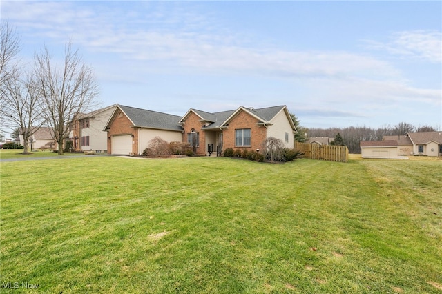 single story home featuring a front yard, brick siding, fence, and an attached garage