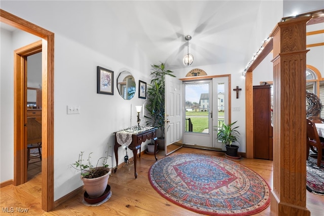 foyer with light wood-style flooring and baseboards