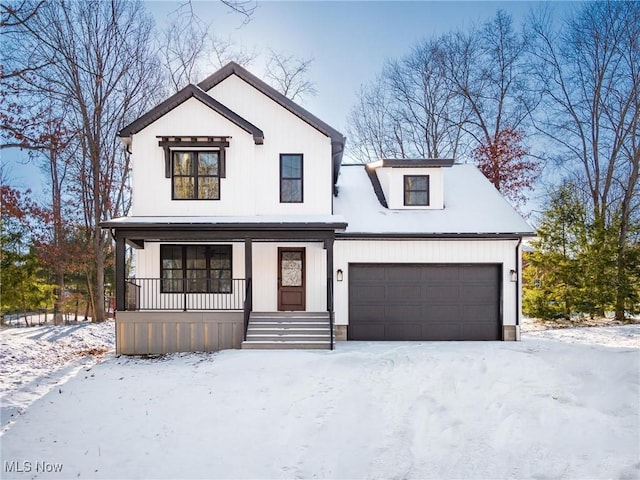 modern farmhouse with an attached garage and covered porch