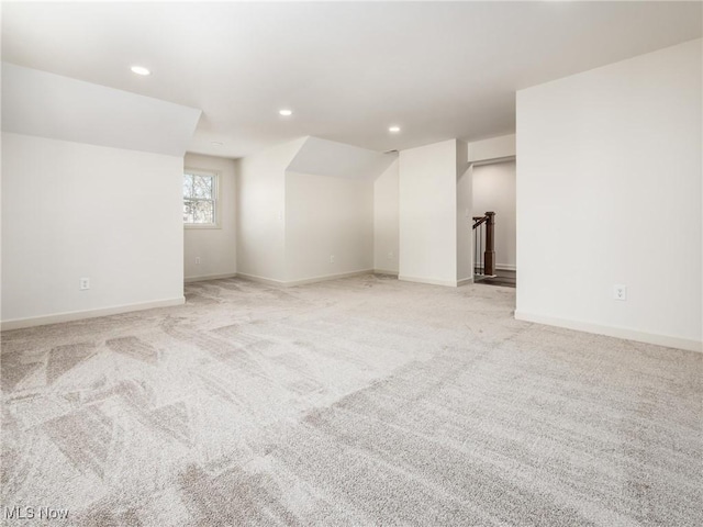 additional living space with light carpet, recessed lighting, and baseboards