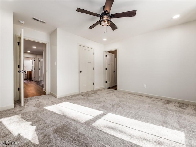 unfurnished bedroom featuring recessed lighting, carpet flooring, a ceiling fan, baseboards, and visible vents