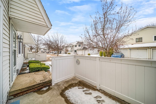 view of patio / terrace with a residential view and fence