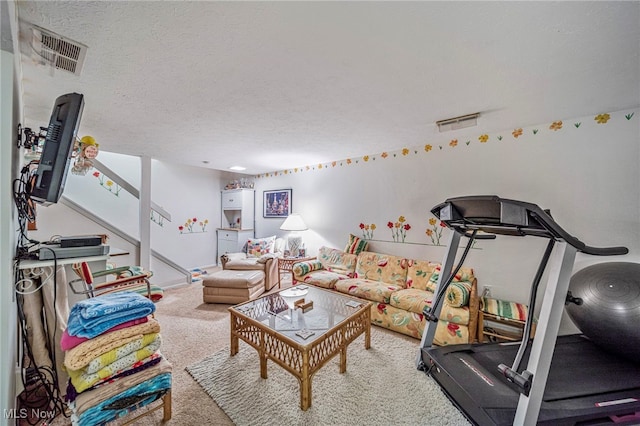 interior space with carpet, visible vents, and a textured ceiling