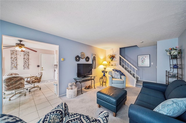 living area featuring baseboards, stairway, a textured ceiling, and light tile patterned floors