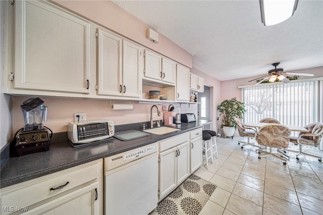 kitchen featuring dishwasher, dark countertops, white cabinetry, open shelves, and a sink