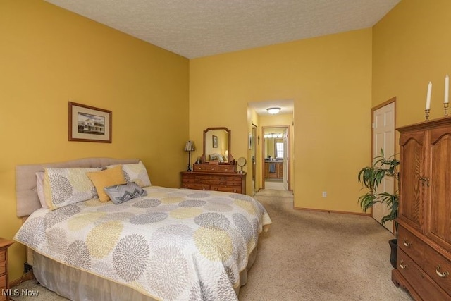 bedroom featuring a textured ceiling, baseboards, and light colored carpet