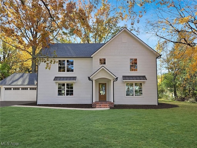 view of front of house with a front lawn, entry steps, driveway, and an attached garage